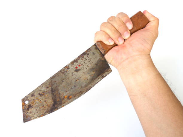 istock Man hand holding big kitchen rusty knife on white background (isolated background). 932284914