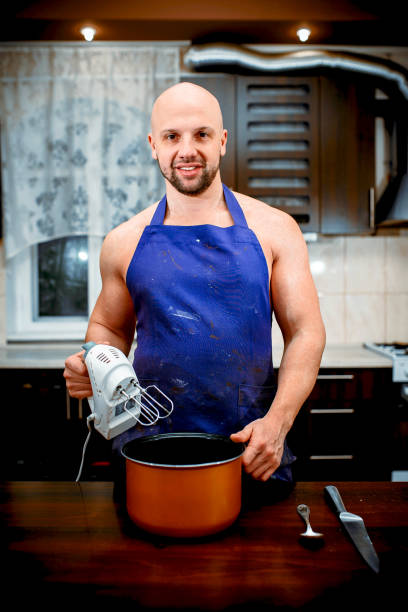 istock A young man is cooking in a large kitchen 932289480