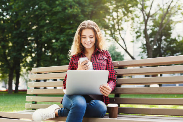 istock Smiling young texting on smartphone outdoors 932289994