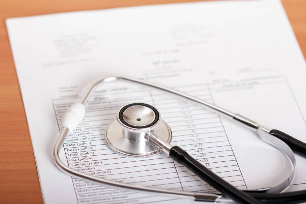 istock Medical diagnostic device phonendoscope, sheet with results of examination, on table 932290556