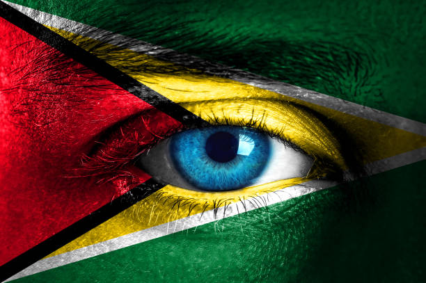istock Human face painted with flag of Guyana 932292958