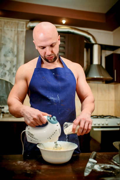 istock A young man is cooking in a large kitchen 932293116