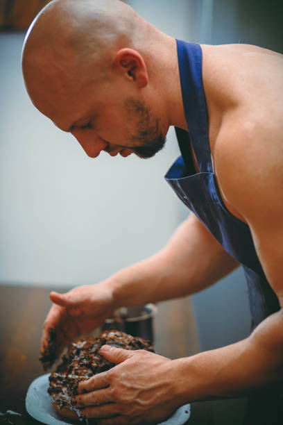 istock A young man is cooking in a large kitchen 932294058