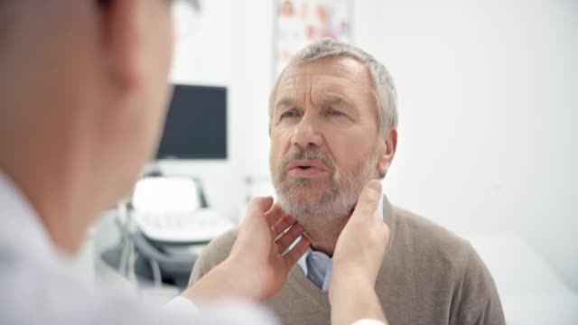 Male doctor checking the patient's lymph nodes