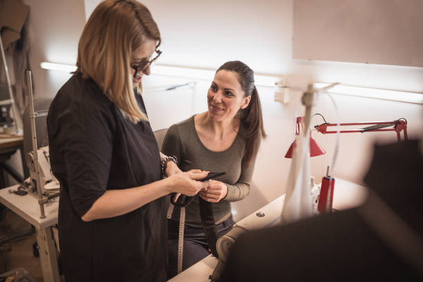 istock Fashion designer in her studio controlling coworkers 932296660