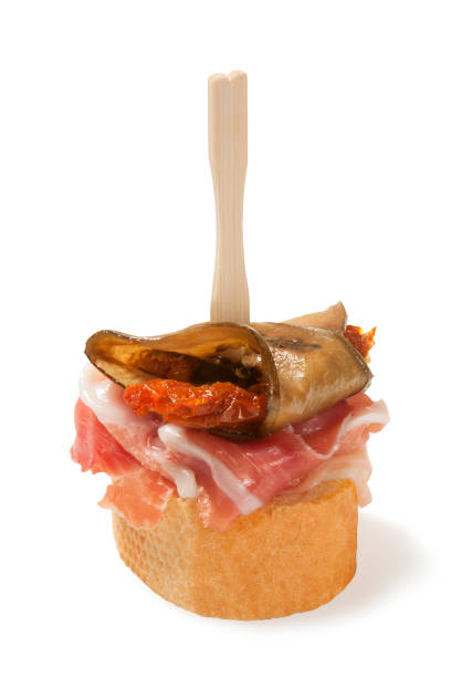 tapas with jamon and eggplant,sun dried tomato, isolated on white stock photo