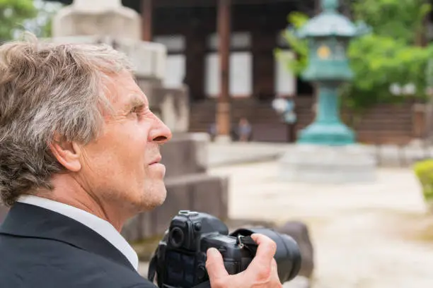 Photo of Man with camera and Zen garden  of Chion-ji temple in Kyoto, Japan