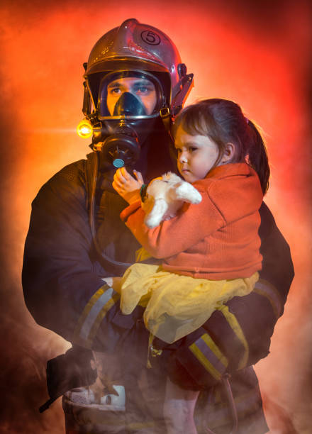 istock Firefighter with Rescued Little Girl 932299438