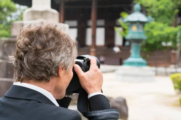 Photo of Man with camera and Zen garden  of Chion-ji temple in Kyoto, Japan