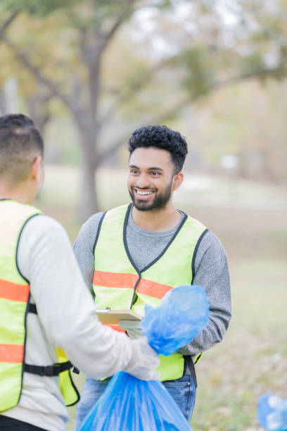 istock Men working together to clean up community 932303978