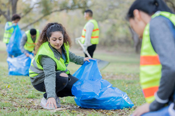 istock Young Indian woman participating in community beautification 932304000