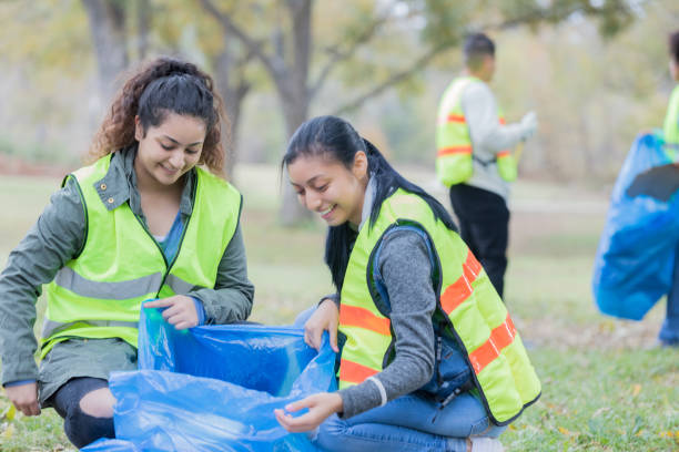 istock Female friends work together during community cleanup day 932304002