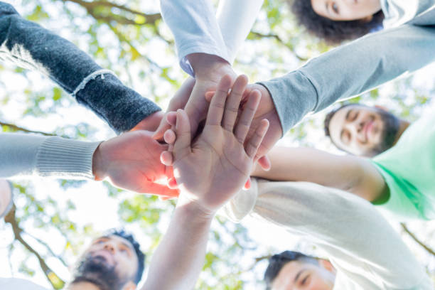 istock Group of people with hands together in unity 932304018
