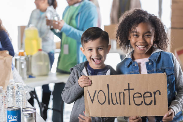 istock Elementary age siblings volunteer in local food bank 932306372