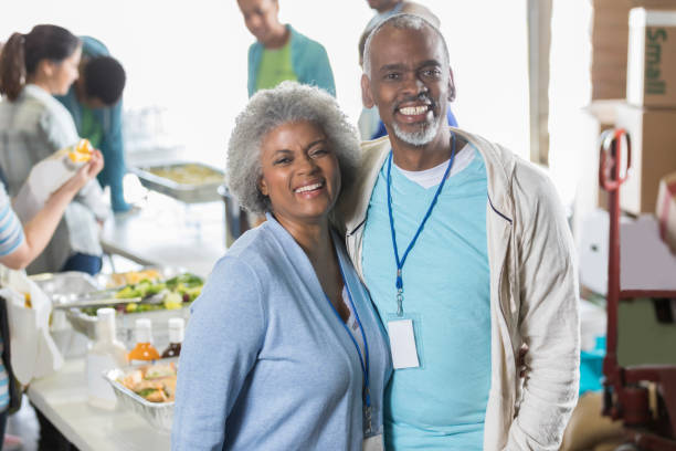 Senior couple volunteer in soup kitchen