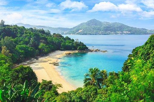 Exotic views through the jungle to uninhabited beach. Blue lagoon. Picturesque bay. Laem sing beach.