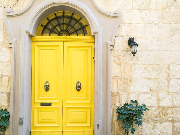 Close up image depicting colorful wooden doors set amid old, weathered stone architecture. Lots of room for copy space.