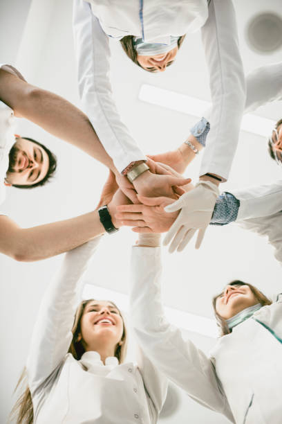 istock Multiethnic Medical Team Stacking Hands in Circle For Success 932314622