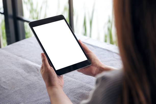 istock a woman holding black tablet pc with blank white desktop screen 932314748