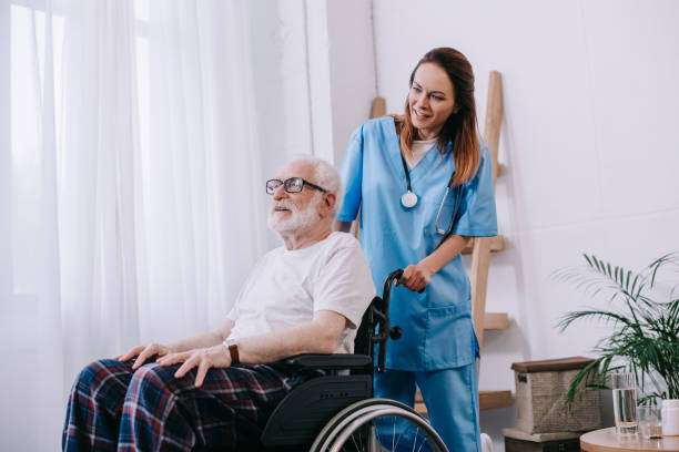 istock Nurse pushing wheelchair with senior man 932321844