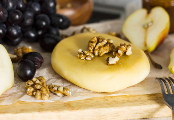 istock Cheese, honey, grapes, pears and nuts on wooden board 932322106