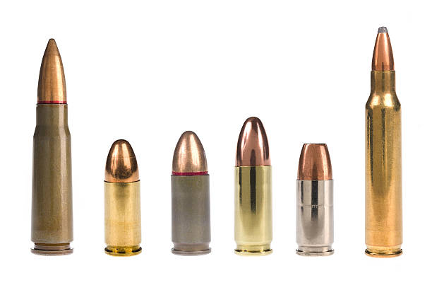 6 different bullets standing on a white background A selection of bullets isolated on white. ammunition photos stock pictures, royalty-free photos & images