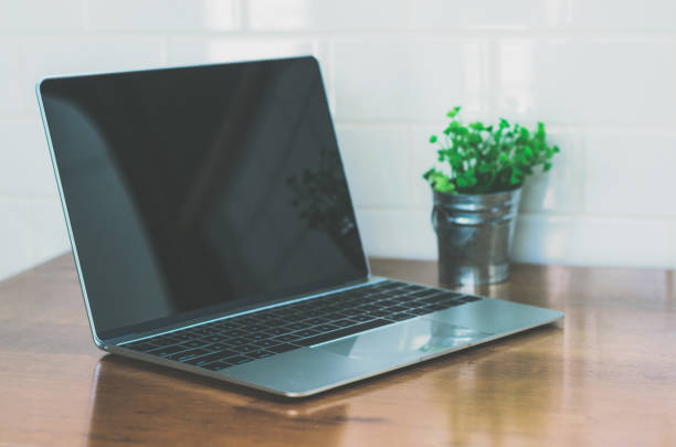 istock empty computer laptop on table in coffee shop with copy space. freelance concept, still holiday concept, laptop working concept. 932333942