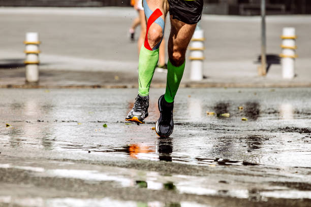 istock legs runner man with kinesio tape and compression socks 932334280