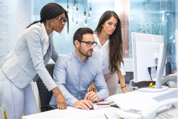 istock Concerned business people looking at financial report on computer screen at office 932339264