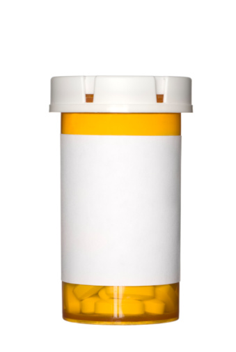 A medical pill bottle with a blank label for copy space and the bottle is isolated on a white background.