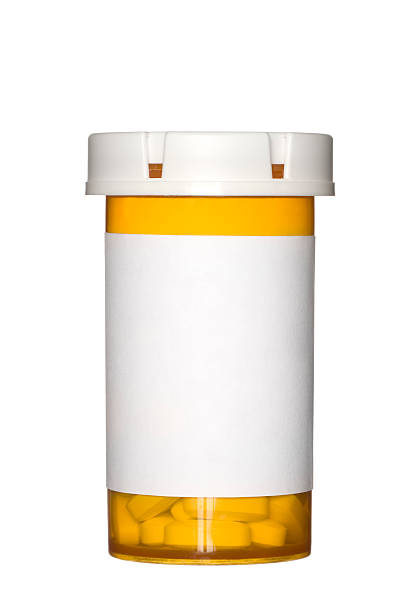 Orange prescription pill bottle on white background A medical pill bottle with a blank label for copy space and the bottle is isolated on a white background. pill bottle stock pictures, royalty-free photos & images