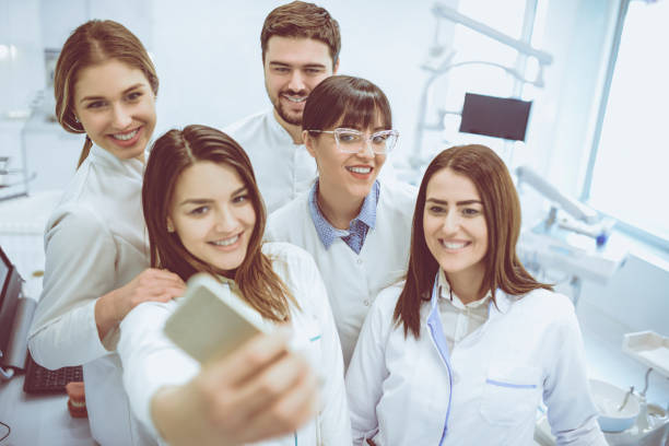 istock Group of Dentists Students Make Selfie with Mobile Phone in Clinic 932344926