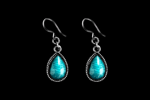 Vintage turquoise elegant silver drop shaped earrings on black background