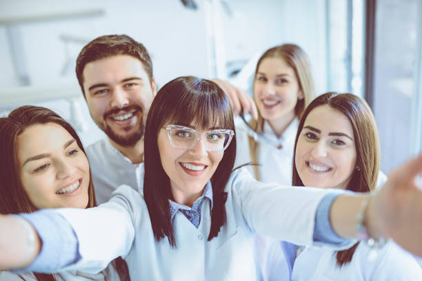 istock Group of Dentists Students Make Selfie in Clinic 932345590