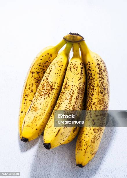 Branch Of Overripe Bananas With Black Dots On The Table Natural Sweetener Concept Of A Healthy Lifestyle Stock Photo - Download Image Now