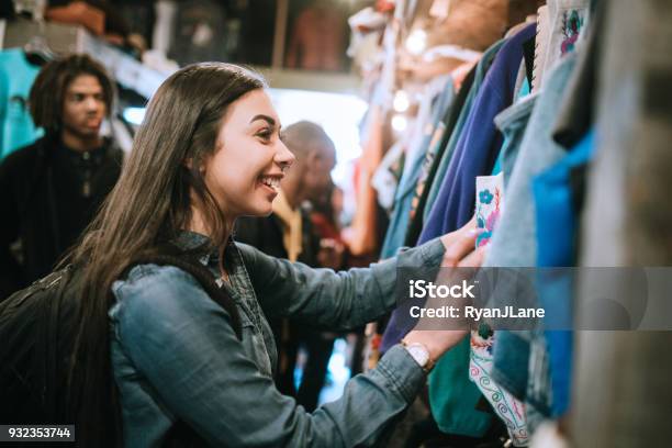 Young Adults Shop For Clothes At Thrift Store Stock Photo - Download Image Now - Shopping, Thrift Store, Retail