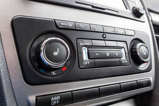 istock Driver hand tuning temperature control in car air conditioning system. Cooling the climate in vehicle interior 932353858