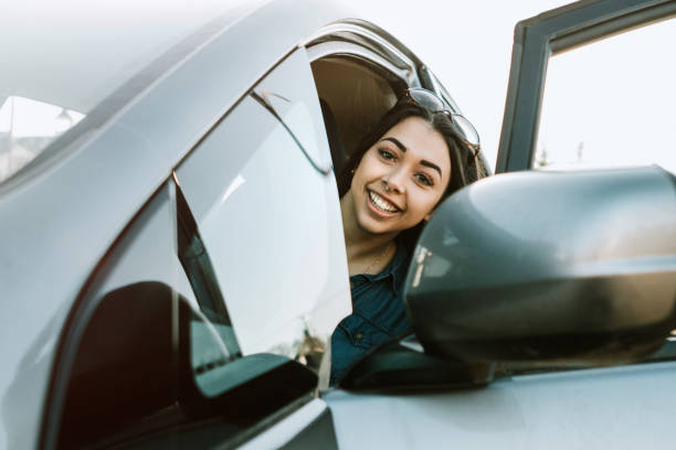 istock Group of Young Adults Having Fun Riding in Car 932354588