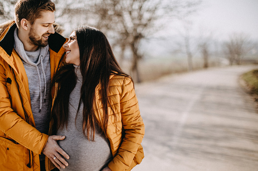 Man Holding Pregnant Belly Stock Photo - Download Image Now - Adult