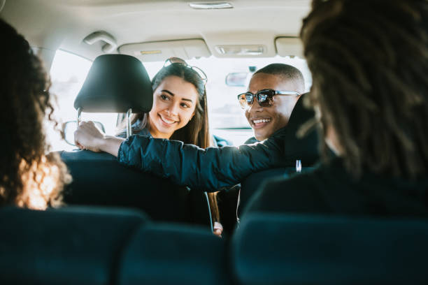 istock Group of Young Adults Having Fun Riding in Car 932356968