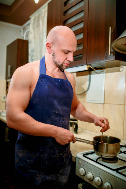 istock A young man chef stands behind a stove 932357040