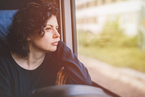 istock Young Woman Traveling In Train - Lost in thought 932361666