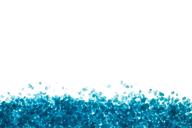 istock Crystals of blue sea salt. Border on white background 932361756