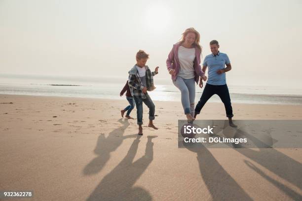 Mother Showing Football Tricks Stock Photo - Download Image Now - Family, Beach, Soccer