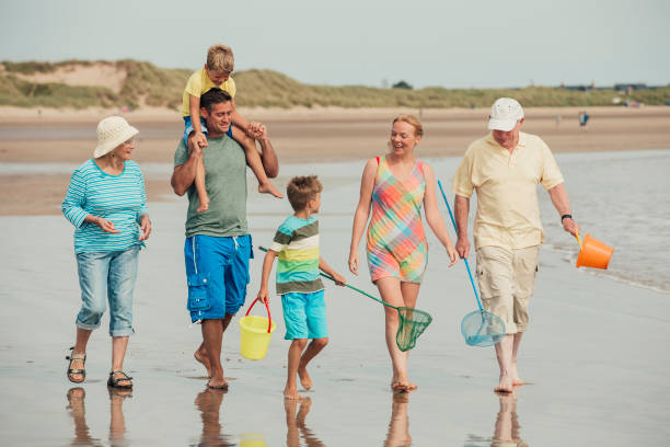 istock Family Walks Along the Beach 932362778