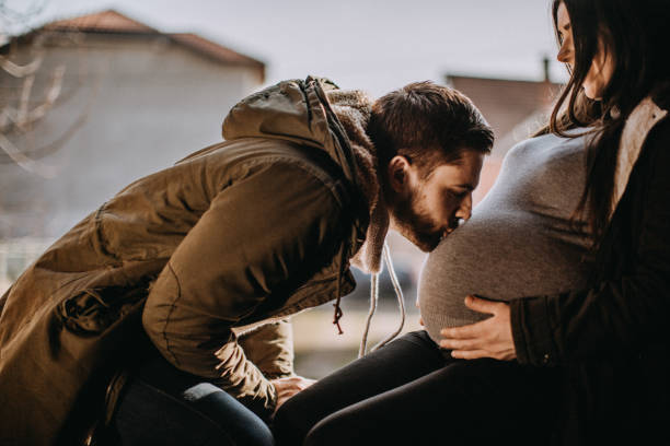 istock Young future parents kissing 932363274