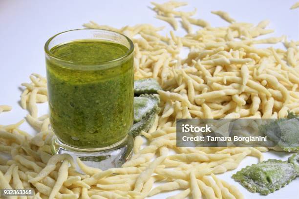 Fresh Homemade Pasta Italian Trophy And Agniolotti On A Light Background With Traditional Basilic Souce Pesto Stock Photo - Download Image Now