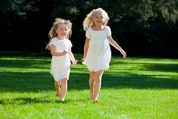 istock Two Pretty Young Girls Running Through A Sunlit Green Park 93236770