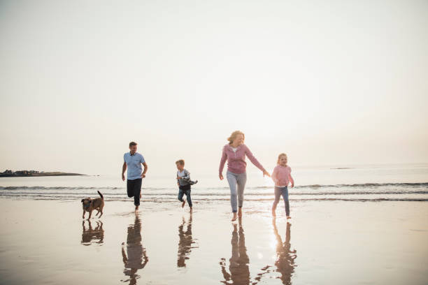 istock Running from the Water at the Beach 932372242