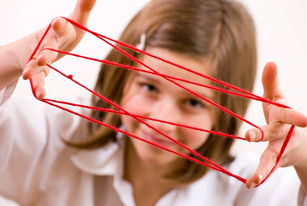 istock Teenager play cat's cradle with red wool 93237225